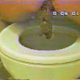 An older, lower quality video clip features a woman sitting on a toilet backwards and taking a shit in three scenes. About 3.5 minutes.